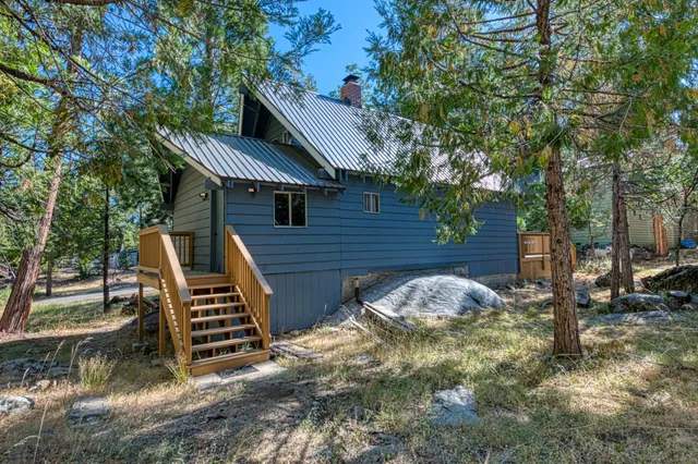 a backyard of a house with table and chairs