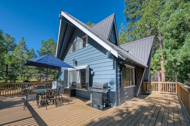 a view of a dinning table and chairs in patio of a house