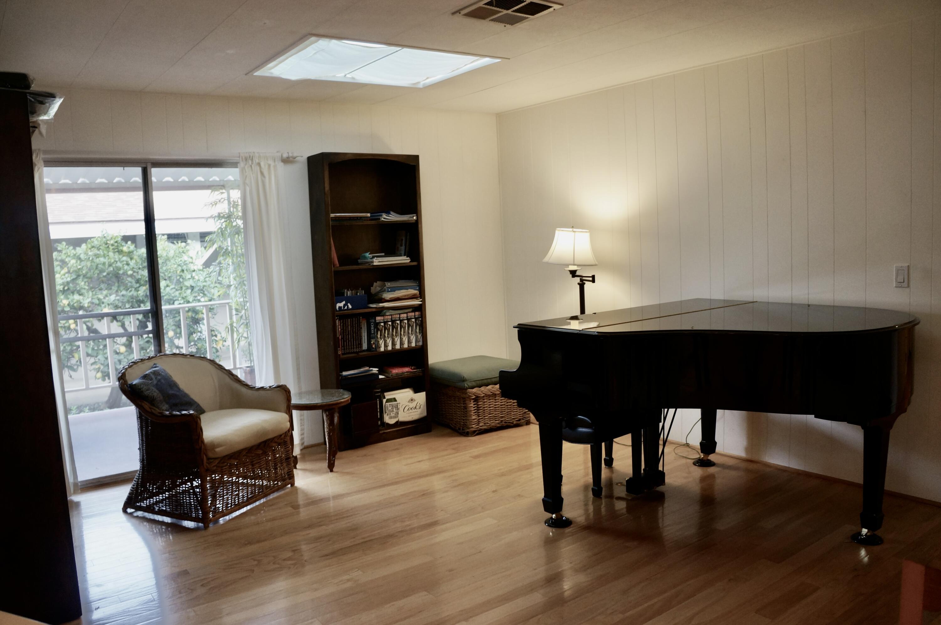 340 Old Mill Road, Unit 20 Santa Barbara, CA 93110 - Photo 8 of 15 a room with furniture lamp large window and wooden floor