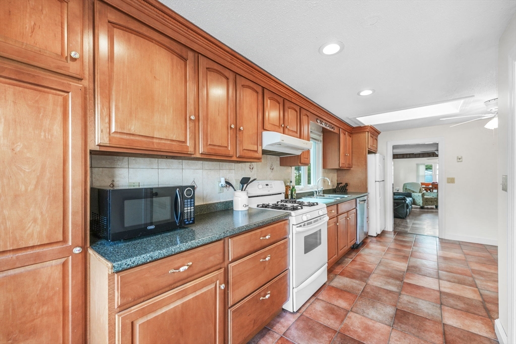 8 Barnes Street Wareham, MA 02571 - Photo 11 of 37 a kitchen with stainless steel appliances granite countertop a stove a sink and a refrigerator