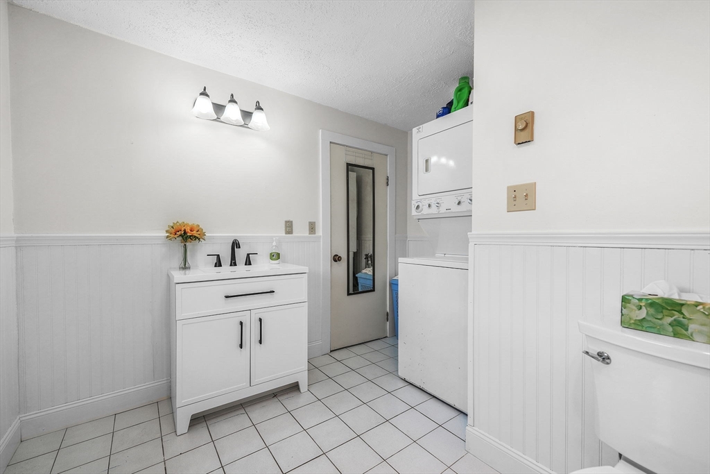 8 Barnes Street Wareham, MA 02571 - Photo 13 of 37 a utility room with cabinets washer and dryer