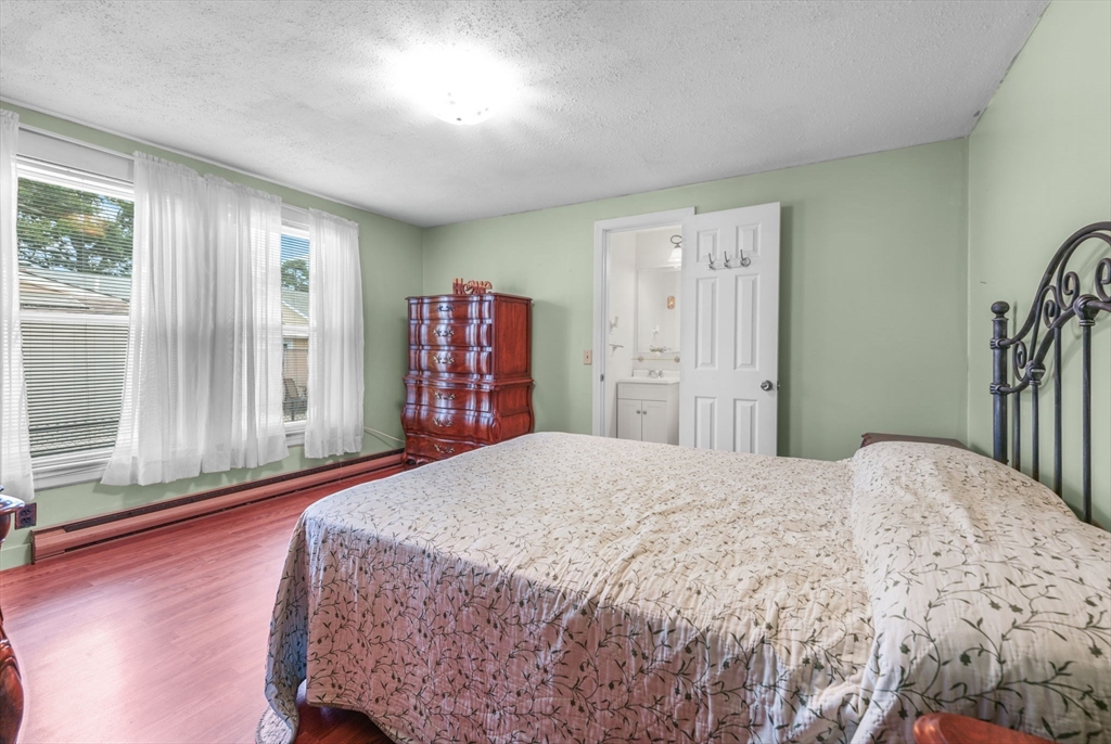 8 Barnes Street Wareham, MA 02571 - Photo 21 of 37 a bedroom with a large bed and wooden floor