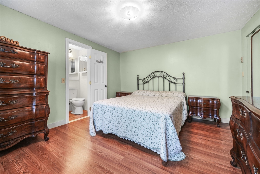 8 Barnes Street Wareham, MA 02571 - Photo 22 of 37 a bedroom with a bed and wooden floor
