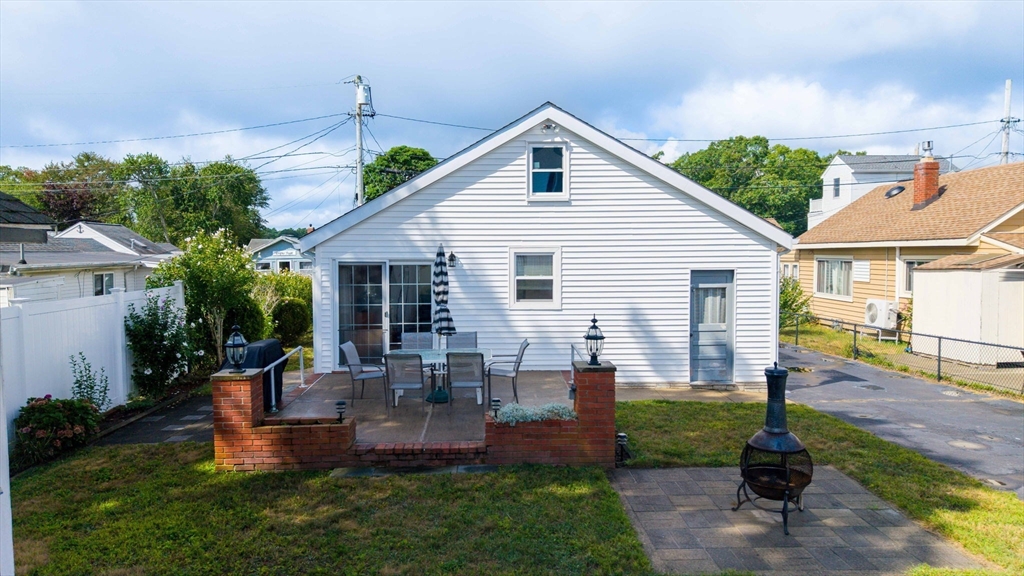 8 Barnes Street Wareham, MA 02571 - Photo 24 of 37 a front view of a house with a yard and potted plants