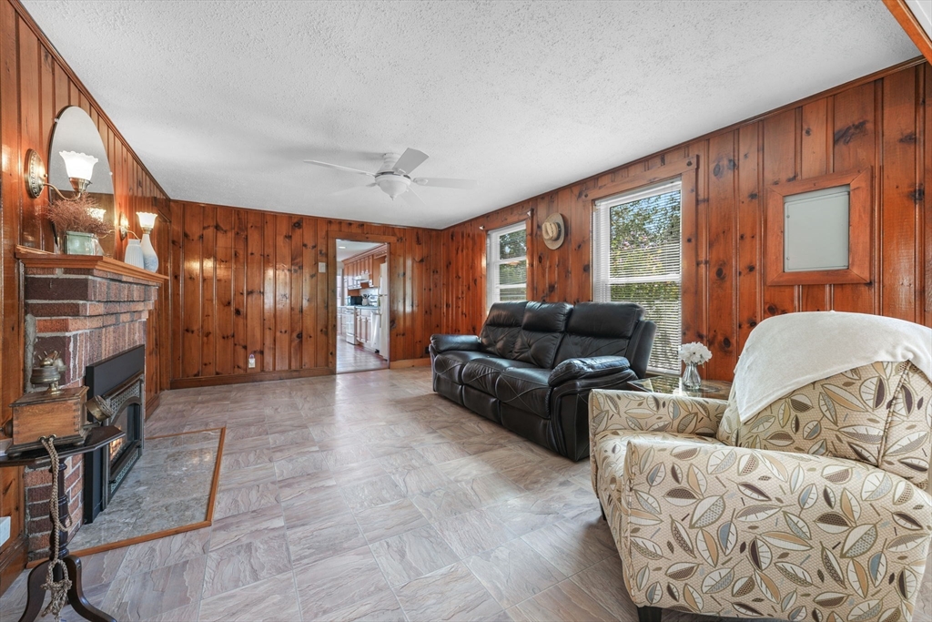 8 Barnes Street Wareham, MA 02571 - Photo 5 of 37 a living room with furniture a fireplace and a large window