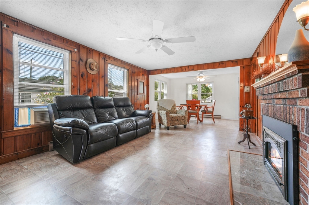 8 Barnes Street Wareham, MA 02571 - Photo 6 of 37 a living room with furniture a large window and a fireplace