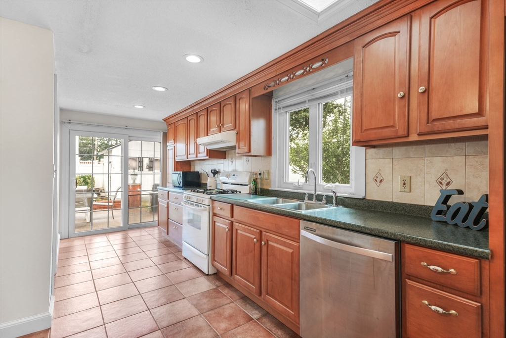 8 Barnes Street Wareham, MA 02571 - Photo 9 of 37 a kitchen with stainless steel appliances granite countertop a stove a sink and a microwave
