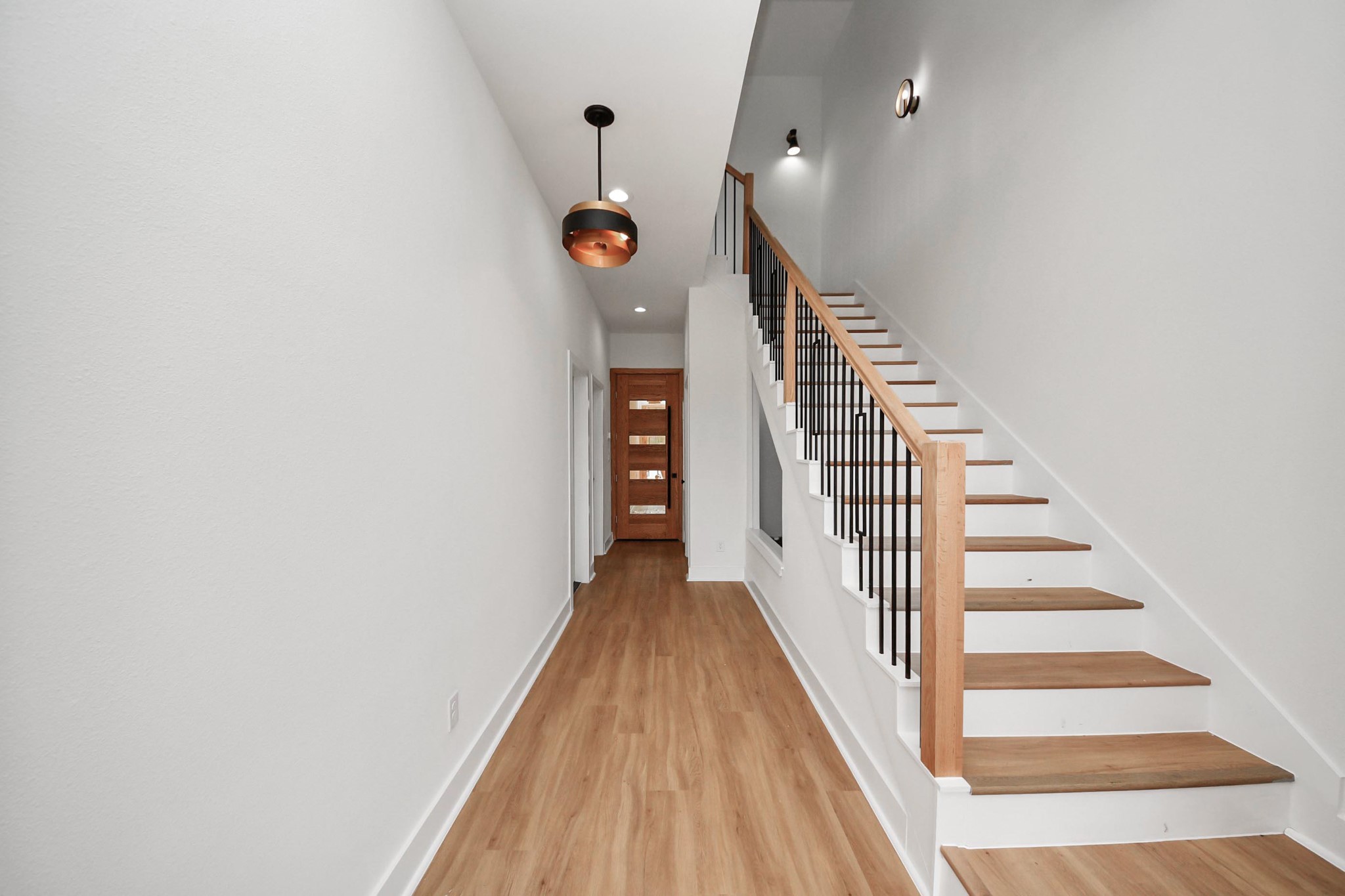 9014 Ferdinand Street Houston, TX 77051 - Photo 11 of 40 a view of a hallway with wooden floor and staircase