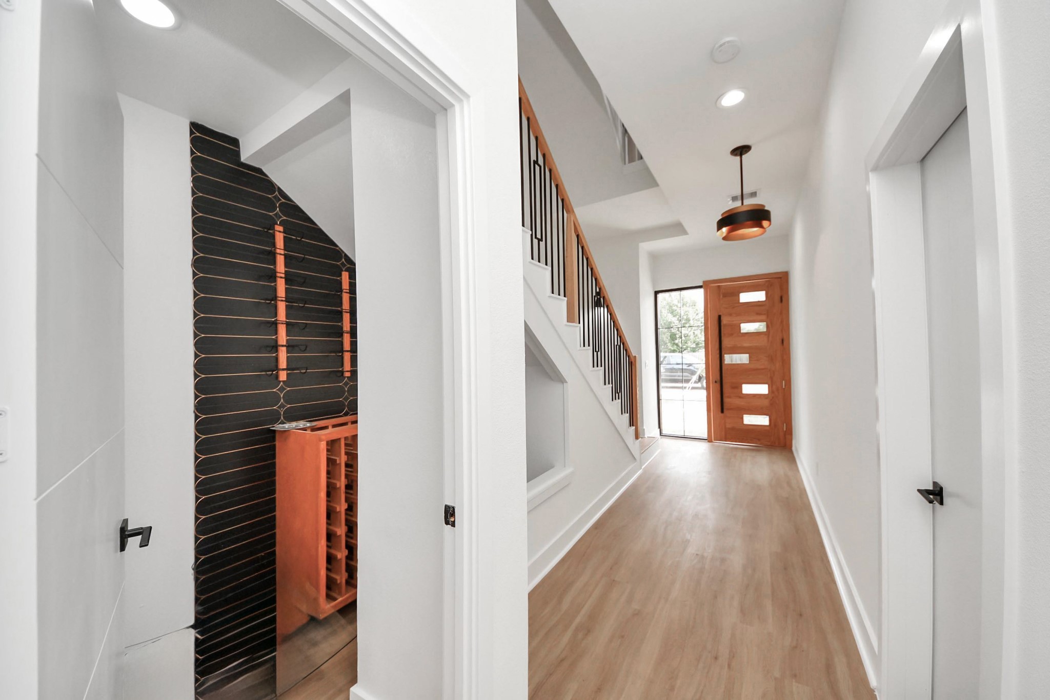 9014 Ferdinand Street Houston, TX 77051 - Photo 12 of 40 a view of hallway with stairs and wooden floor