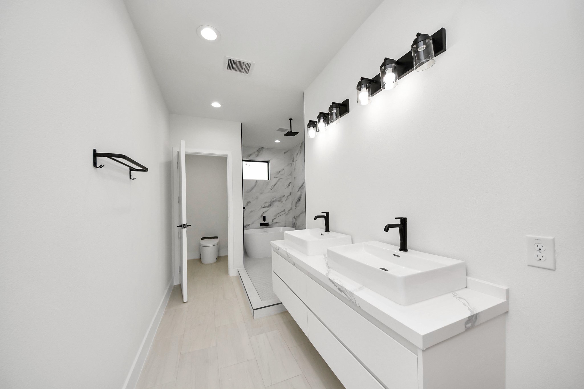 9014 Ferdinand Street Houston, TX 77051 - Photo 20 of 40 a spacious bathroom with a sink and a mirror