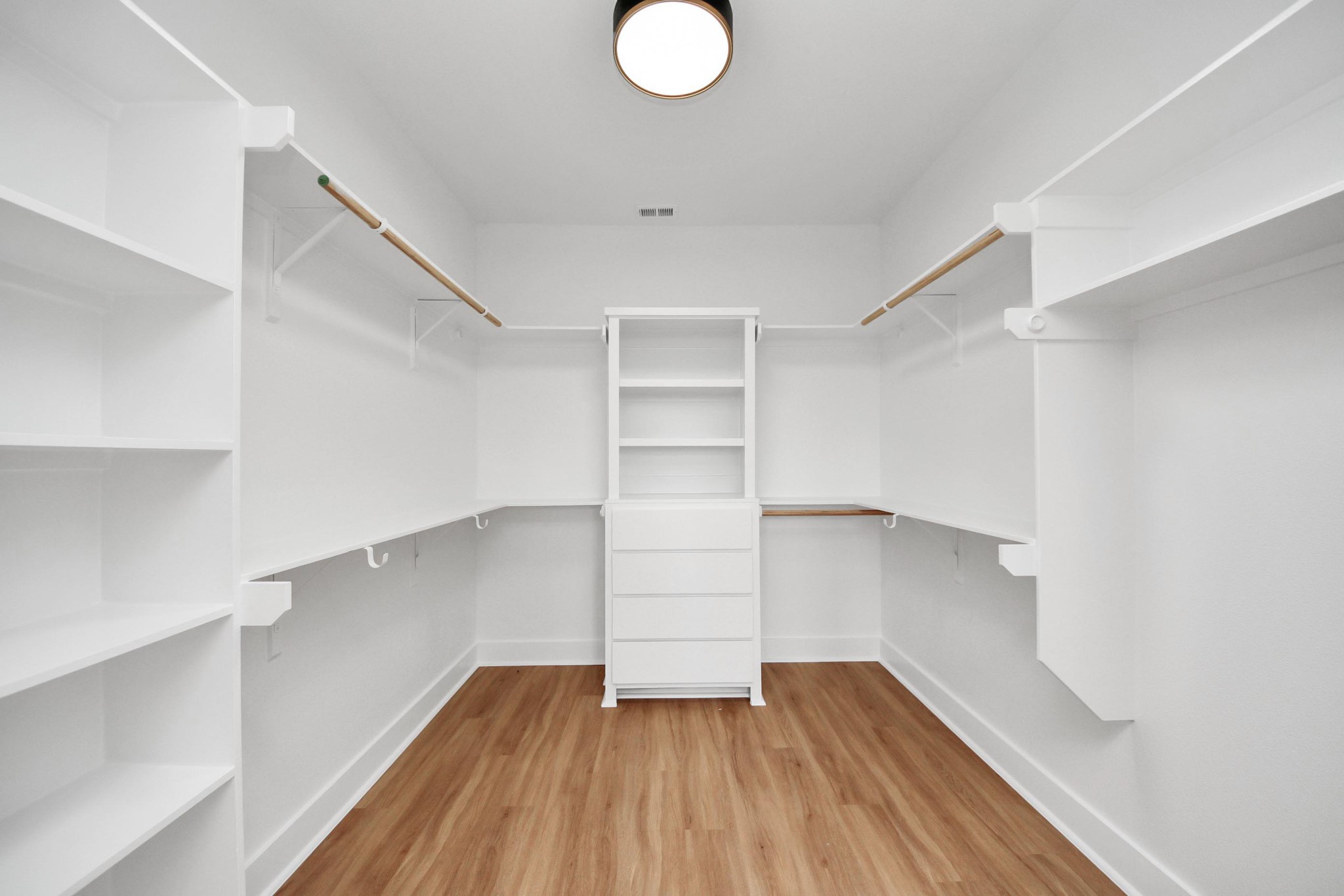9014 Ferdinand Street Houston, TX 77051 - Photo 23 of 40 a view of walk in closet with wooden floor and cabinets