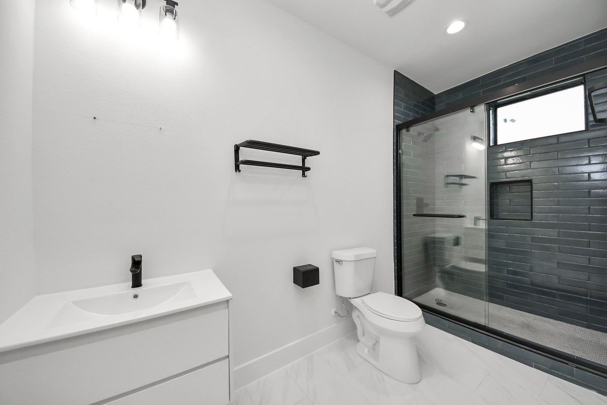 9014 Ferdinand Street Houston, TX 77051 - Photo 25 of 40 a bathroom with a sink a toilet and shower