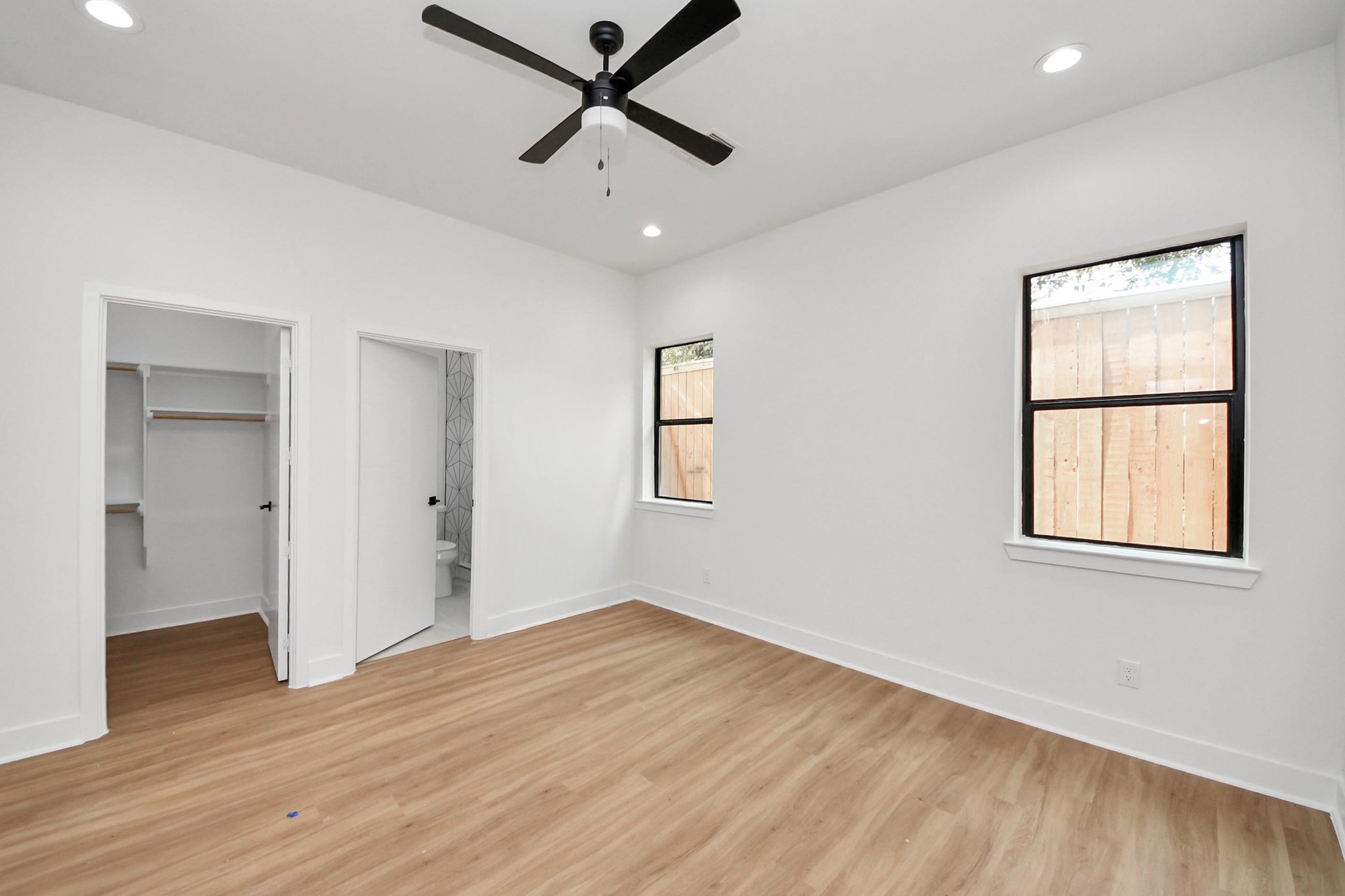 9014 Ferdinand Street Houston, TX 77051 - Photo 26 of 40 a view of empty room with wooden floor and fan