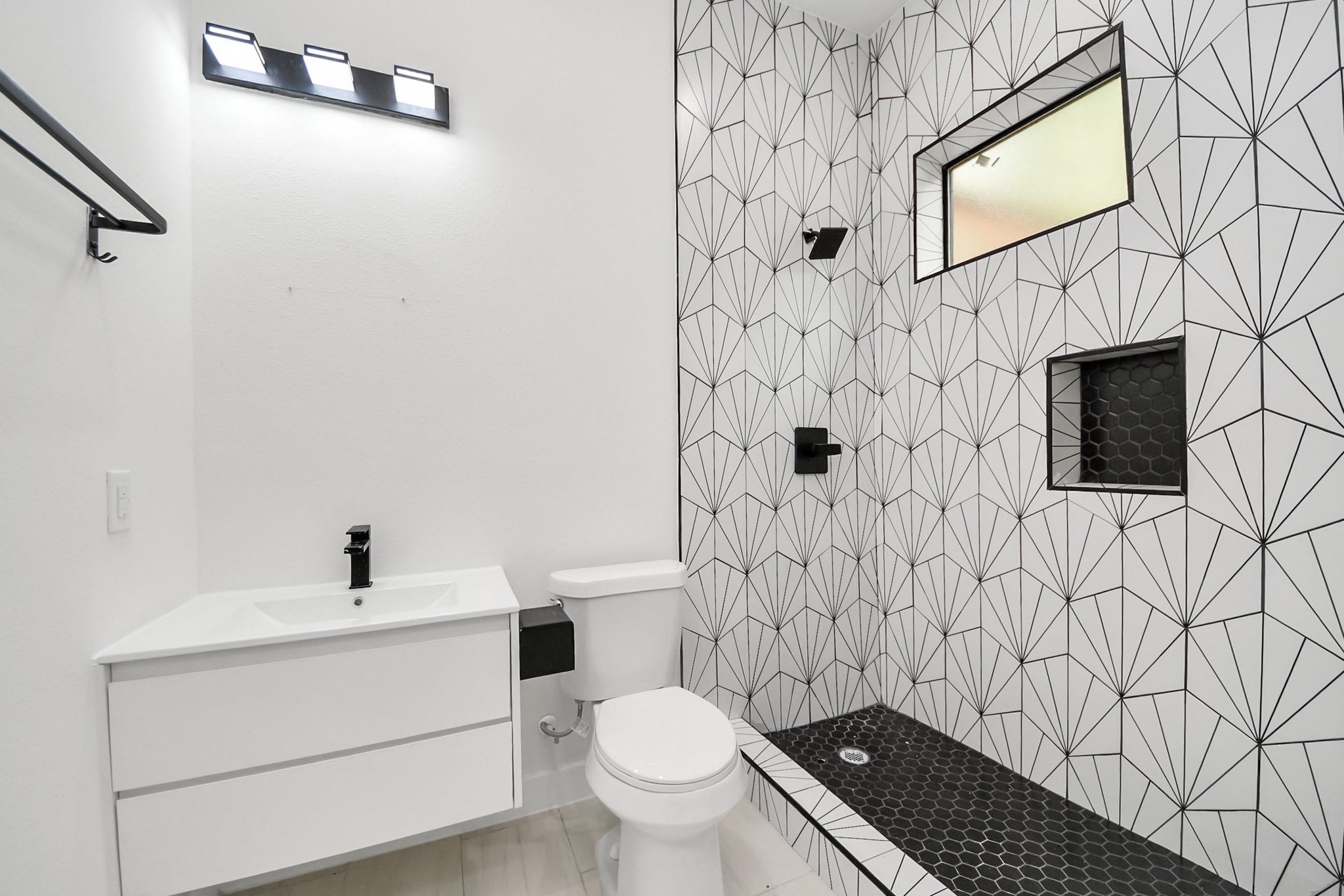 9014 Ferdinand Street Houston, TX 77051 - Photo 27 of 40 a bathroom with a toilet sink and a mirror
