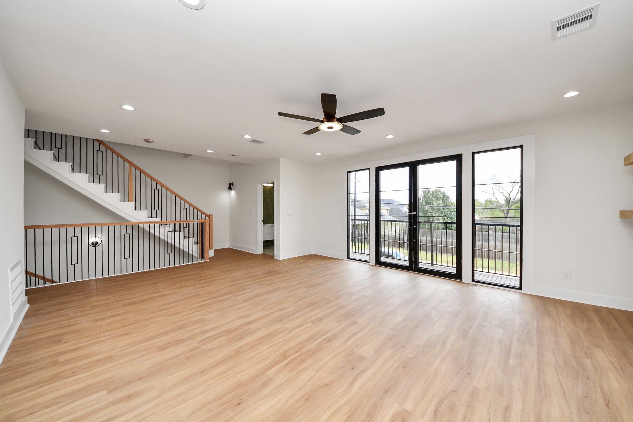9014 Ferdinand Street Houston, TX 77051 - Photo 8 of 40 a view of an empty room with wooden floor and a ceiling fan