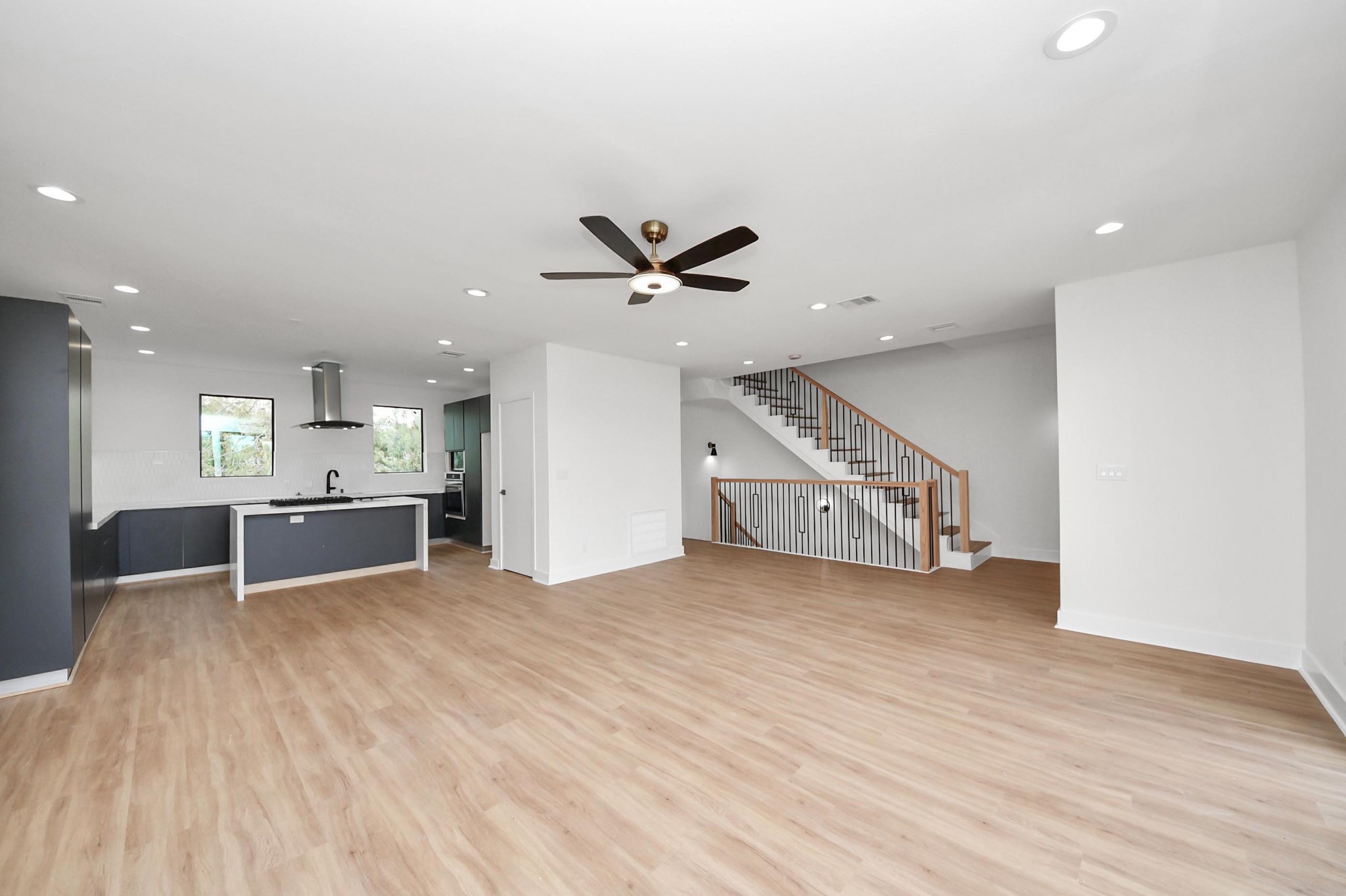 9014 Ferdinand Street Houston, TX 77051 - Photo 10 of 40 a view of an empty room with wooden floor and a ceiling fan