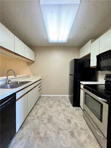 a kitchen with stainless steel appliances a sink and a stove
