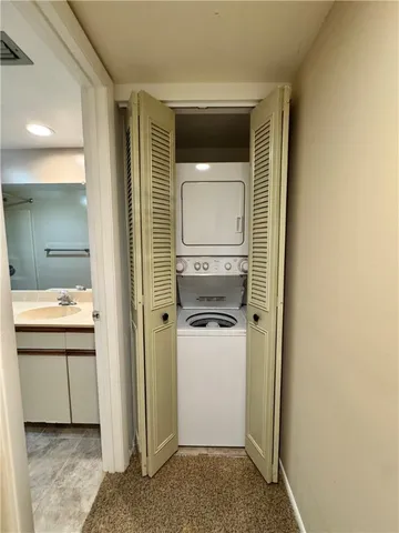 a bathroom with a granite countertop sink a toilet a mirror and bathtub