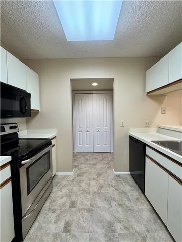 a kitchen with stainless steel appliances granite countertop a stove and a sink