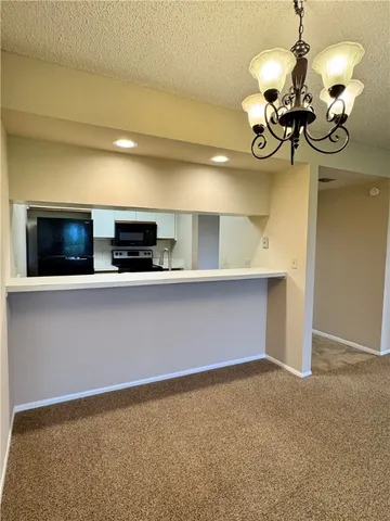 a kitchen with a chandelier