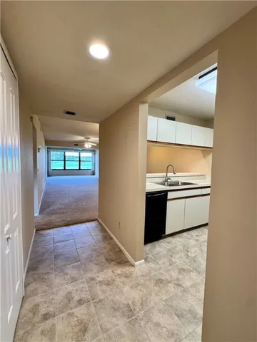 a view of a kitchen with a sink and an oven