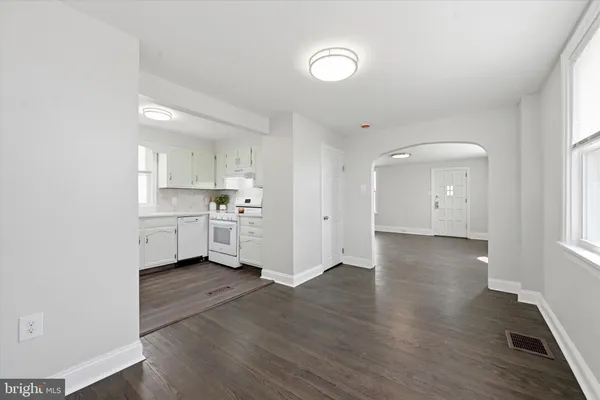 a view of a kitchen with wooden floor and windows