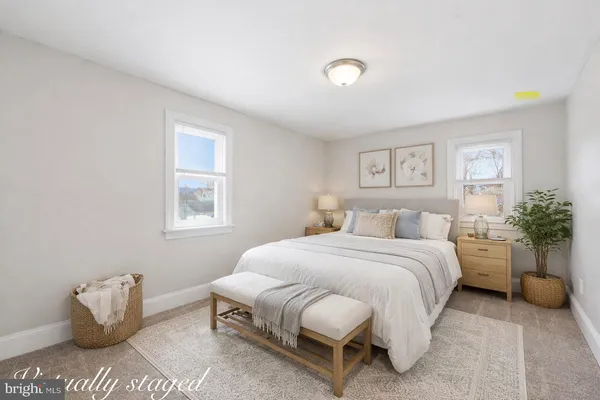 a bedroom with a bed and a potted plant