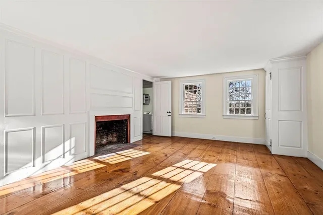 a view of a livingroom with a fireplace and window