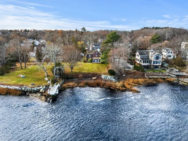an aerial view of a houses with a yard