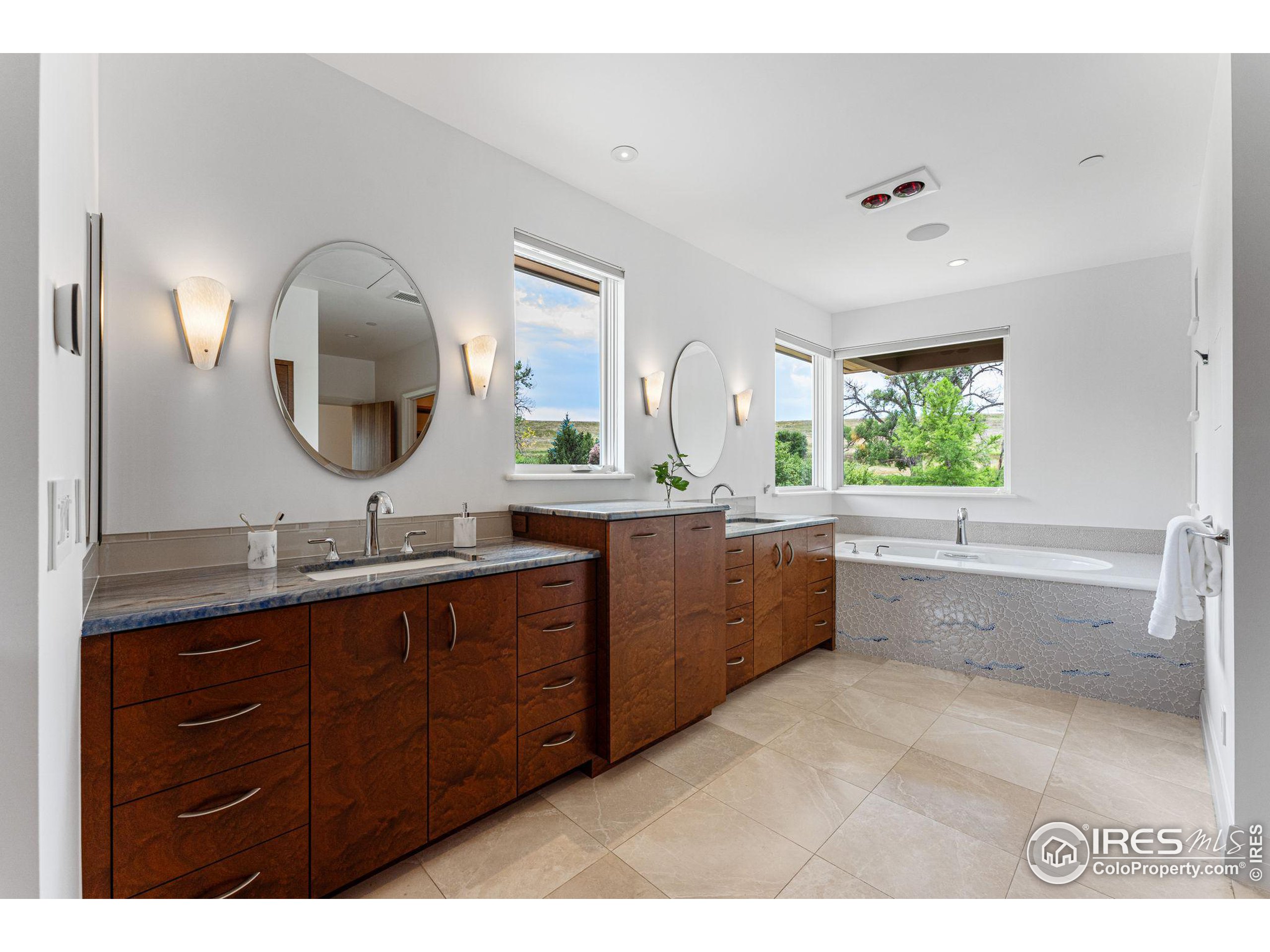 1000 Spring Drive Boulder, CO 80303 - Photo 23 of 40 a bathroom with a granite countertop sink a mirror and a bathtub