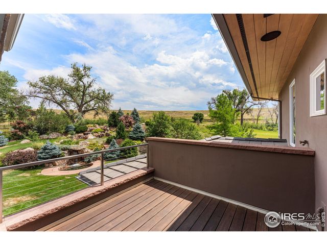 a view of balcony with wooden floor and fence
