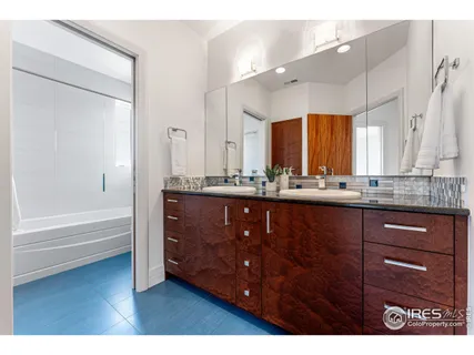 a bathroom with a tub sink and mirror