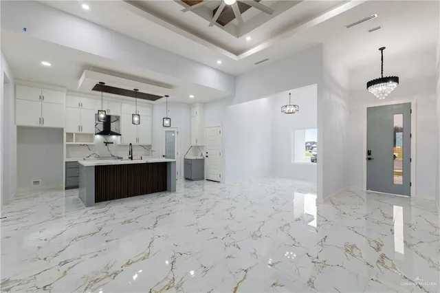 a view of kitchen with refrigerator sink and cabinets