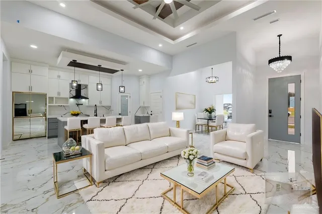 a living room with furniture and kitchen view