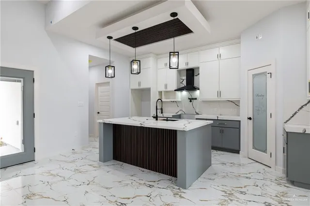 a kitchen with a sink cabinets and stainless steel appliances