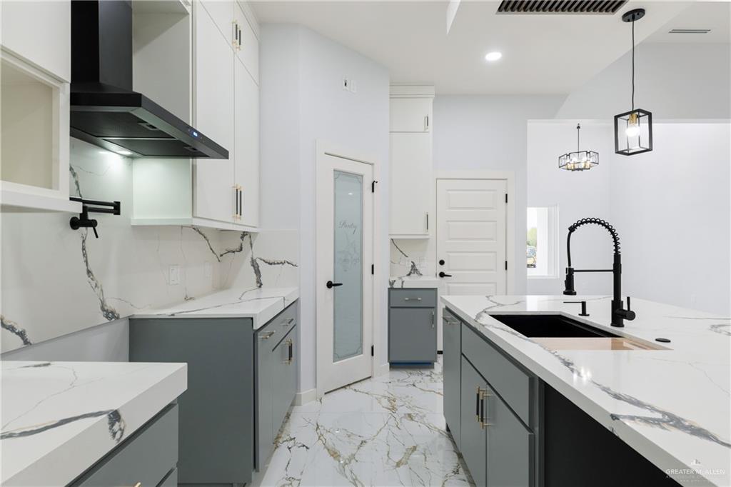 2630 Marky Street Harlingen, TX 78552 - Photo 7 of 42 a kitchen with a sink cabinets and stainless steel appliances
