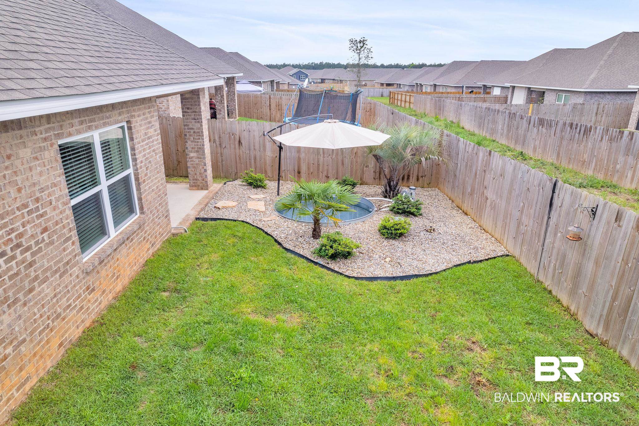 31650 Memphis Loop Daphne, AL 36527 - Photo 49 of 68 Fenced backyard featuring a residential view, a patio, and a trampoline