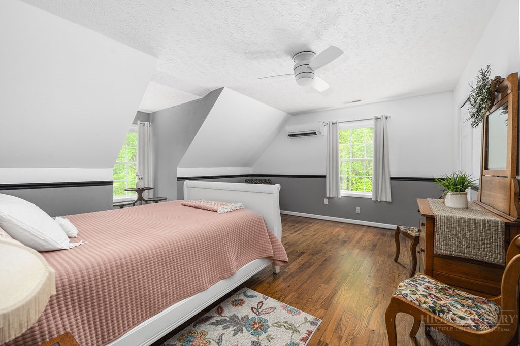 970 Vox Road Sparta, NC 28675 - Photo 33 of 50 a bedroom with a bed wooden floor and window