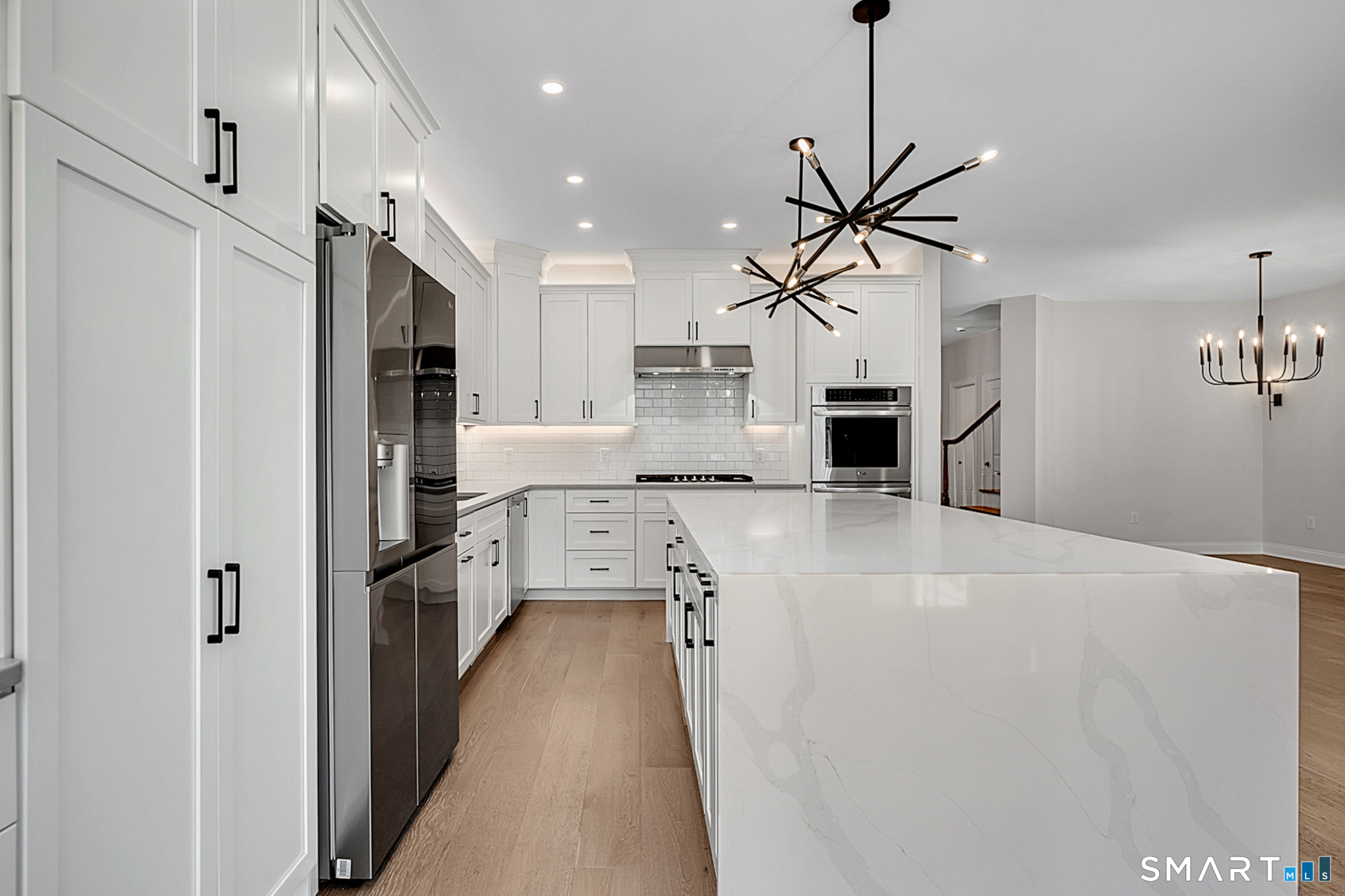 193 Ridgewood Drive, Unit 193 Middlebury, CT 06762 - Photo 14 of 40 a kitchen with kitchen island a counter top space a sink stainless steel appliances and cabinets