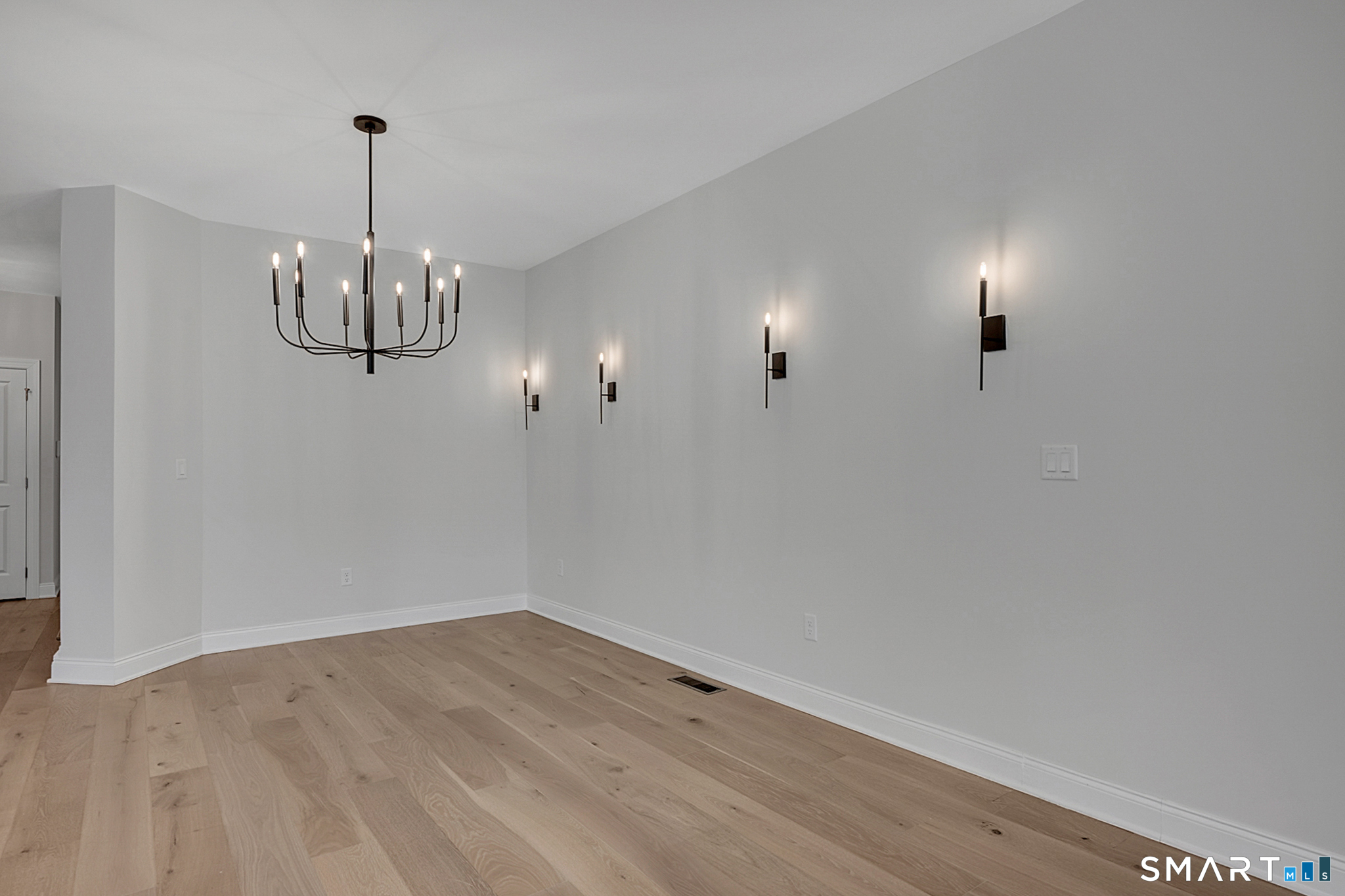 193 Ridgewood Drive, Unit 193 Middlebury, CT 06762 - Photo 15 of 40 a view of a room with wooden floor and chandelier