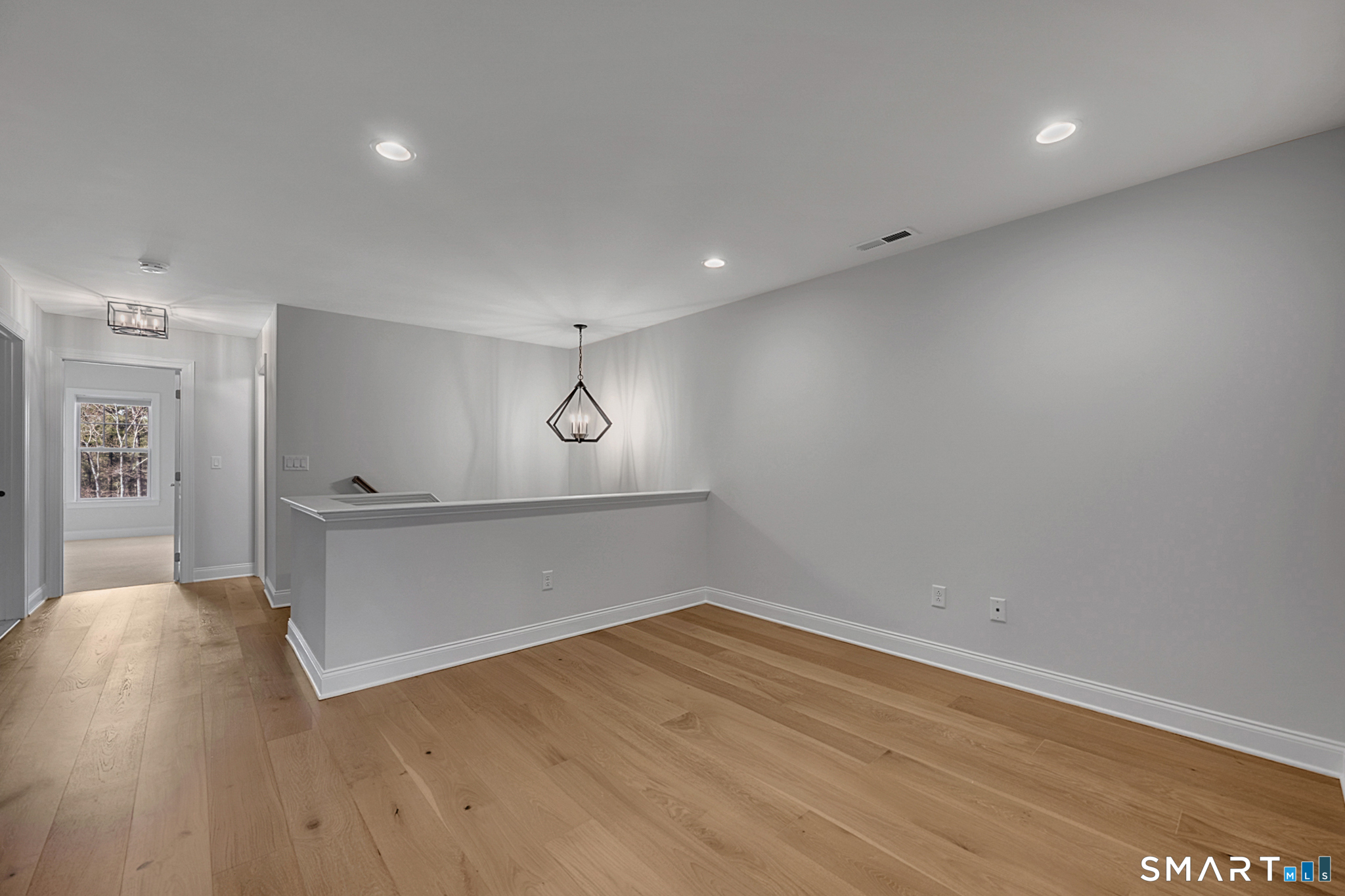 193 Ridgewood Drive, Unit 193 Middlebury, CT 06762 - Photo 16 of 40 a view of an empty room with wooden floor