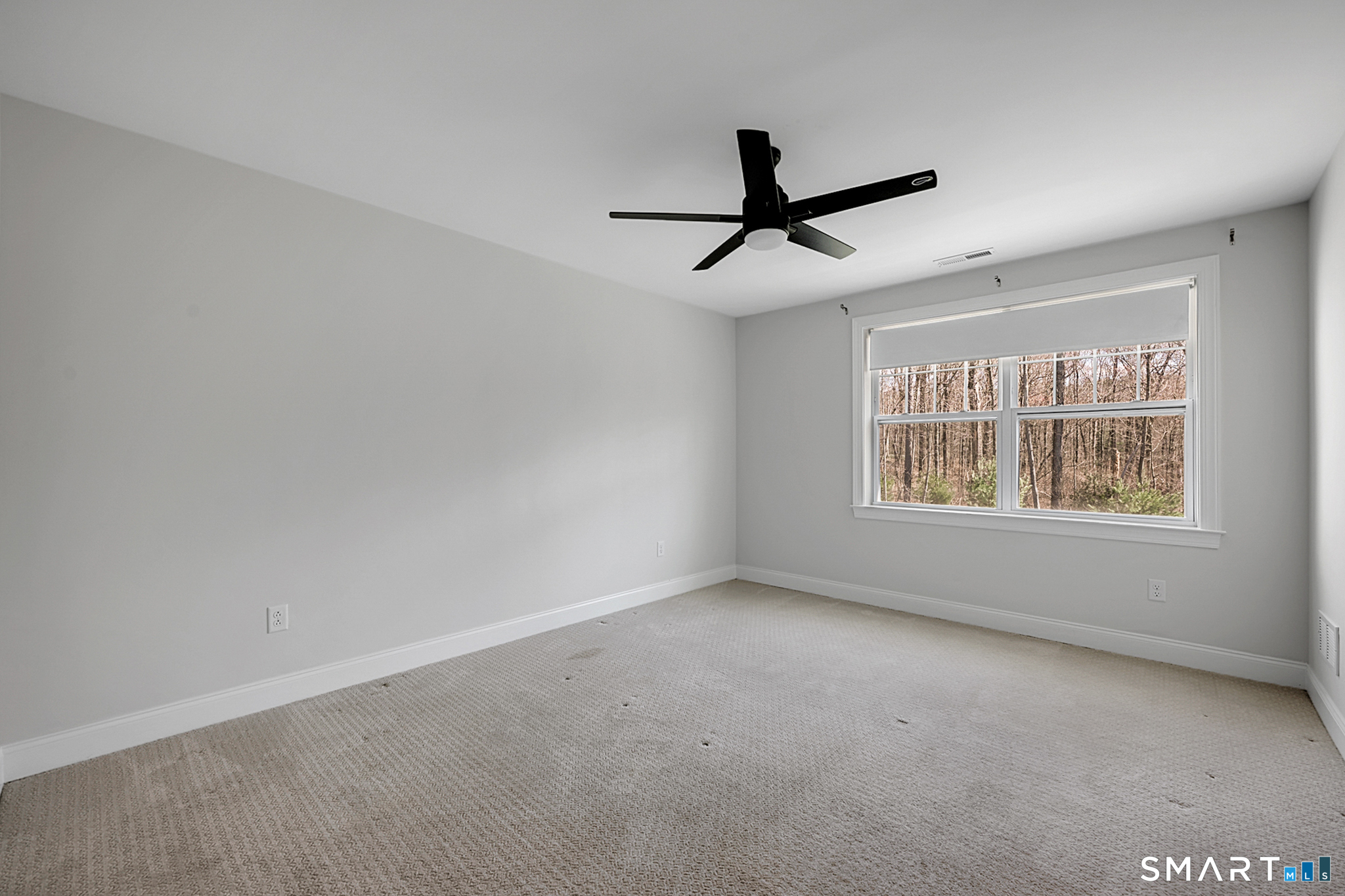 193 Ridgewood Drive, Unit 193 Middlebury, CT 06762 - Photo 20 of 40 a view of a livingroom with a ceiling fan and window