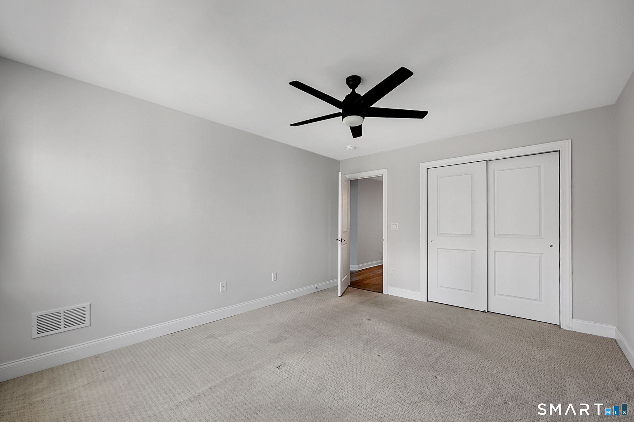 193 Ridgewood Drive, Unit 193 Middlebury, CT 06762 - Photo 21 of 40 an empty room with a ceiling fan and a ceiling fan
