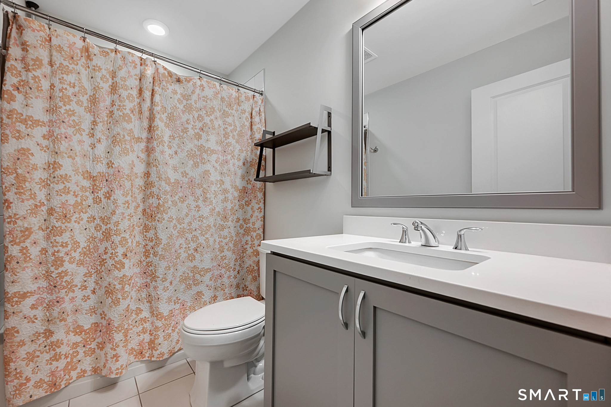 193 Ridgewood Drive, Unit 193 Middlebury, CT 06762 - Photo 22 of 40 a bathroom with a granite countertop sink toilet and mirror