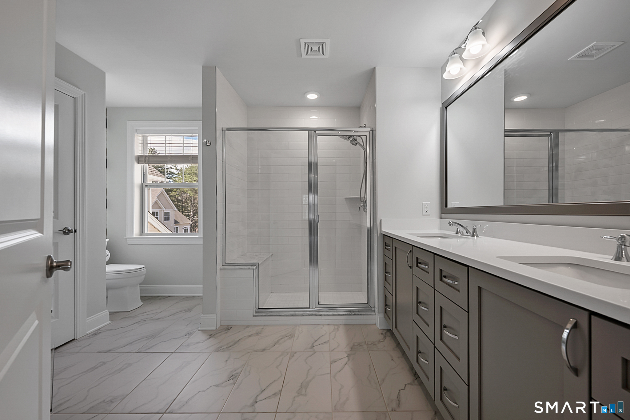 193 Ridgewood Drive, Unit 193 Middlebury, CT 06762 - Photo 28 of 40 a spacious bathroom with a granite countertop sink a toilet a shower and a mirror