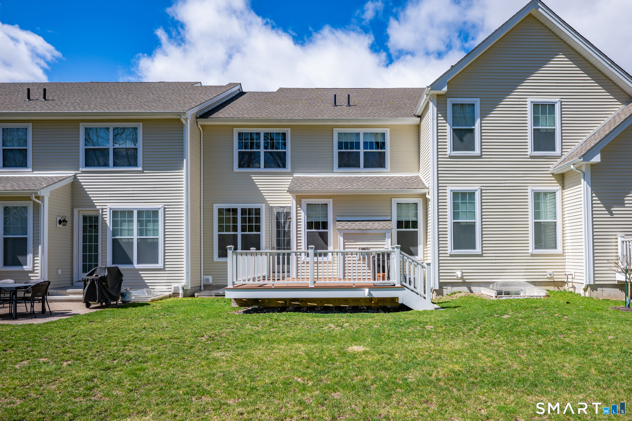193 Ridgewood Drive, Unit 193 Middlebury, CT 06762 - Photo 32 of 40 a front view of a house with a yard
