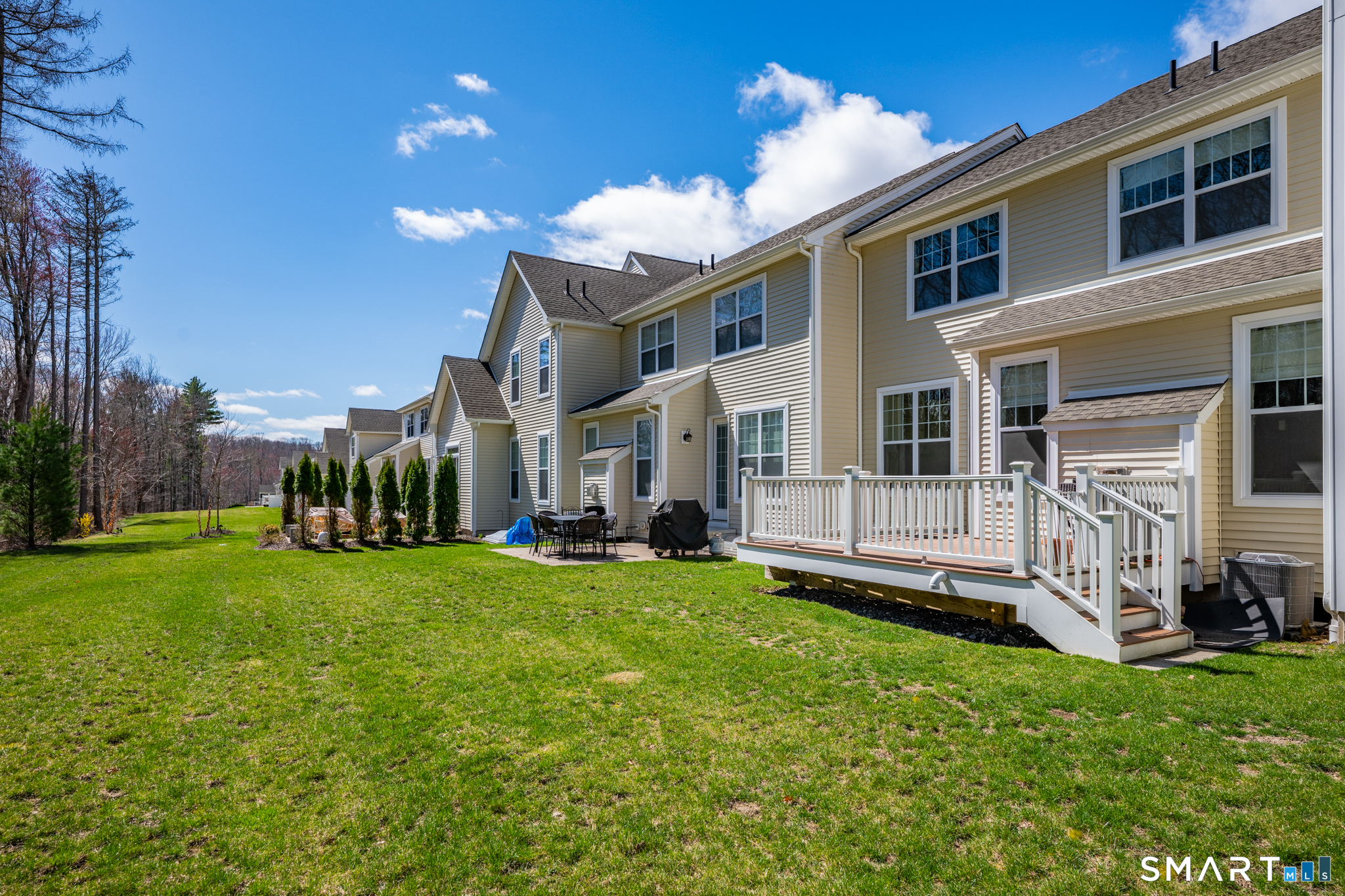 193 Ridgewood Drive, Unit 193 Middlebury, CT 06762 - Photo 35 of 40 a view of a house with a yard and sitting area