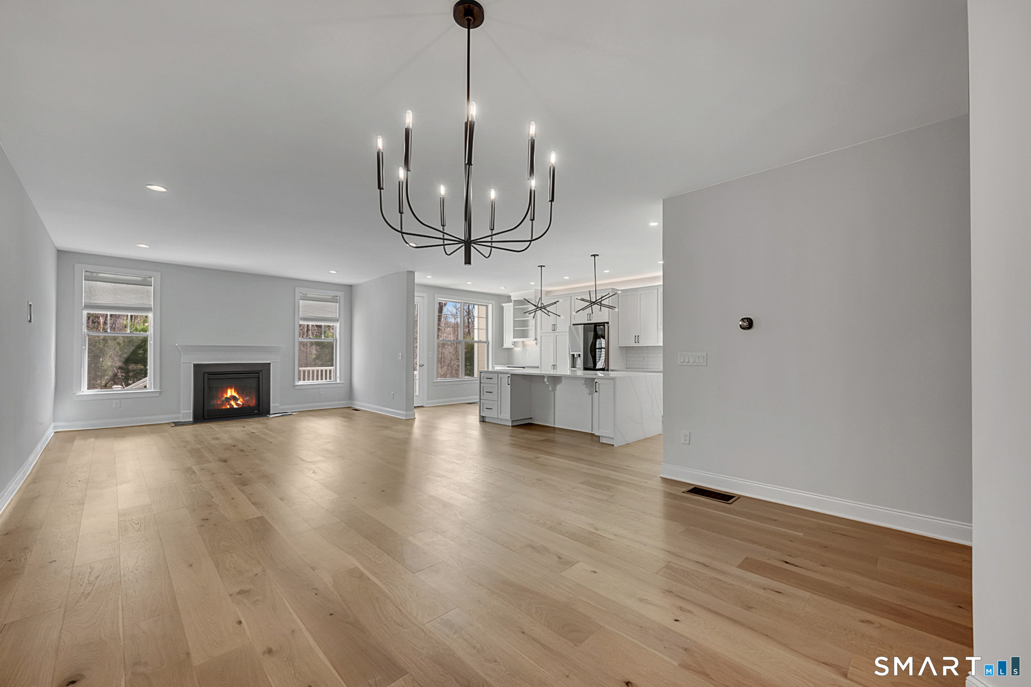 193 Ridgewood Drive, Unit 193 Middlebury, CT 06762 - Photo 8 of 40 a view of empty room with wooden floor and fireplace