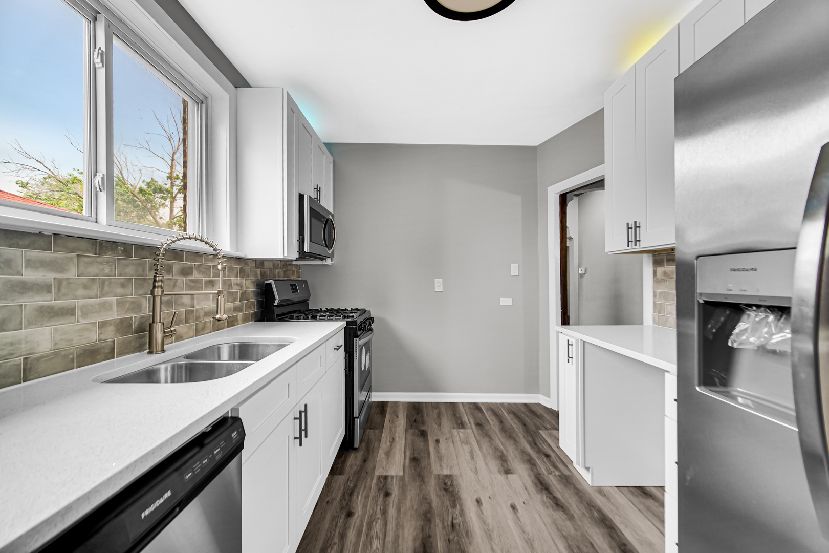 248 Ruth Street Calumet City, IL 60409 - Photo 12 of 19 a kitchen with a sink and a stove top oven