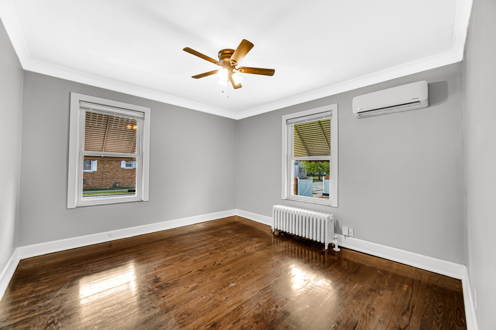 248 Ruth Street Calumet City, IL 60409 - Photo 14 of 19 a view of empty room with wooden floor and fan